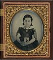 Girl in mourning dress holding framed photograph of her father