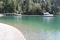 Motorboat at a dock with a forest on the shore