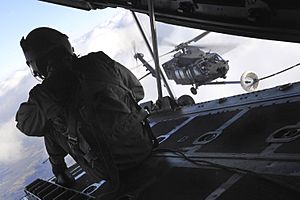 SSG Jeremy Mayo of the 9th Special Operations Squadron observes an aerial refueling of a U.S. Army MH-60K Blackhawk helicopter