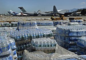 US Navy 100128-N-5345W-098 Pallets of humanitarian aid and bottled water are lined up in a staging area just off the tarmac of Aerodome de Jacmel, an airport in Port-au-Prince