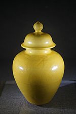 Yellow glazed pot and cover with hidden streak designs