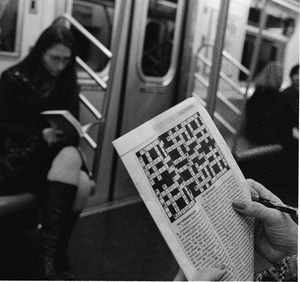 A person works on a crossword puzzle in the subway 2008