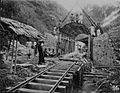 COLLECTIE TROPENMUSEUM Arbeiders poseren bij een in aanbouw zijnde spoorwegtunnel in de bergen TMnr 60047638
