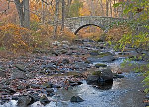 Pocantico River with stone bridge in Rockefeller State Park Preserve, Sleepy Hollow, NY