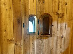 The leper window near the altar in the Hopperstad Stave Church Replica allowed the individuals with Leprosy to see the service and receive communion while remaining outside of the church