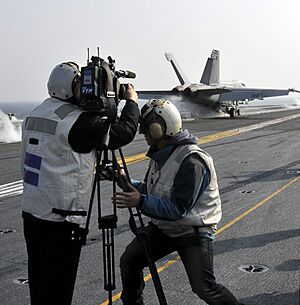 US Navy 101129-N-7103C-162 Reporters from Korean news media capture footage of an F-A-18E Super Hornet assigned to the Eagles of Strike Fighter Squ