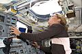 Astronaut Julie Payette looks through an overhead window on Space Shuttle Endeavour