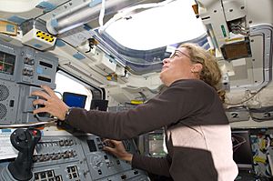 Astronaut Julie Payette looks through an overhead window on Space Shuttle Endeavour