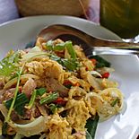 Khua chin som sai khai is a dish prepared with dry-fried pickled pork and egg. Chin som is the northern Thai name for naem.