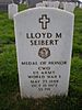 A white marble headstone with a cross, "LLOYD M. SEIBERT", a medal, then "MEDAL OF HONOR" "CWO" "US ARMY" "WORLD WAR I" "MAY 23 1889" "OCT 15 1972" "SS PH"