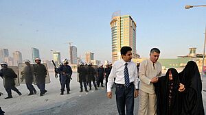 Nabeel Rajab and Abdulhadi Alkhawaja helping an old woman after police attacked a peaceful protest in August 2010