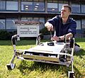 US Navy 060427-N-1825C-001 Combat Systems Sciences and Technology Program Naval Postgraduate student Ensign Tom Dunbar, works with an autonomous robot originally designed to maneuver in agricultural settings