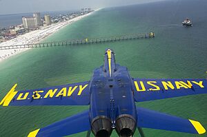 US Navy 110707-N-BA418-065 An F-A-18 Hornet flies inverted over Pensacola Beach while performing the double farvel maneuver during a practice fligh