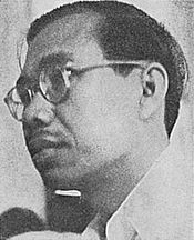 A man with glasses, looking left