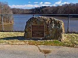 A photograph of an onsite dedication stone to wilderness activist Bernard Frank, after whom the lake is named in honor.
