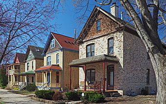 Four small brick houses in a row with consistent style