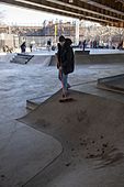 A volunteer sweeps up dirt at Golconda Skatepark