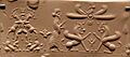 Achaemenid cylinder seal showing 2 scenes. An Achaemenid king before 2 sphinxes (below god Ahura Mazda). Supernatural creature fighting 2 ibexes. 6th-4th century BCE. From Hillah, Iraq. British Museum (cropped)