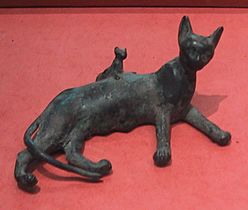 Ancient Egyptian bronze statue of a reclining cat and kitten