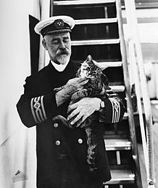 Captain A. J. Hailey in uniform with a cat on the first C.P. R.M.S. Empress of Canada