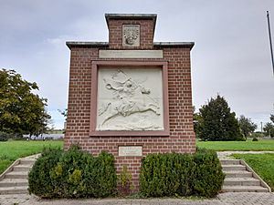 Square monument with battle details.
