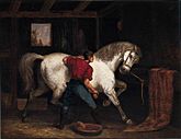Oil painting of a horse groom, with his back to the viewer, brushing a large, white horse that is pawing the ground and turning to look at the groom.