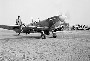 A Supermarine Spitfire Mk IXE of No. 412 Squadron RCAF, armed with a 250-lb GP bomb under each wing, taxies out for a sortie at Volkel, Holland, 27 October 1944. CL1451