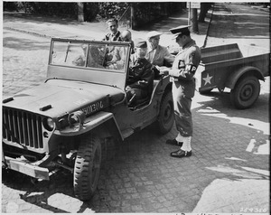 Civilian Photo Technicians (in back of jeep) working for Counter Intelligence Corps, are accounted for by Captain... - NARA - 198977
