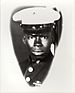 A black-and-white photo of a black man wearing his dress blue Marine Corps uniform with hat