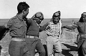 King Hussein of Jordan dancing dabkeh with bedouins, 1960