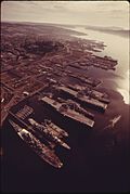 AERIAL VIEW LOOKING NORTHEAST ACROSS THE PUGET SOUND NAVAL SHIPYARD IN DOWNTOWN BREMERTON, AND UP RICH PASSAGE.... - NARA - 556946