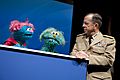 Defense.gov News Photo 100413-N-0696M-244 - Chairman of the Joint Chiefs of Staff Adm. Mike Mullen speaks with Sesame Street Muppets Jesse and Rosita at a preview of the PBS special When