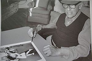 Eisenstaedt signing "VJ day" print on August 23, 1995 at his Menemsha cabin on Martha's Vineyard