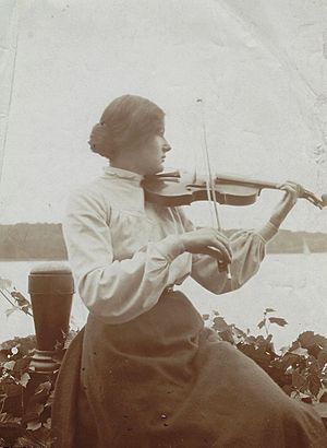 Rebecca Clarke in the yard at Gayton Corner, Harrow, with violin, c. 1908.