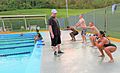 Participants with the Water Warrior class perform squats prior to entering the pool at Camp Foster, Okinawa, Japan, July 6, 2011 110706-M-VD776-004 (cropped)