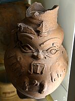 Pottery vessel. Applique face of god Bes on surface. Pink-brown ware. From Egypt. 26th Dynasty. The Petrie Museum of Egyptian Archaeology, London
