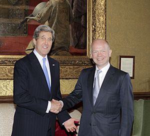 Secretary Kerry Shakes Hands with UK Foreign Secretary William Hague