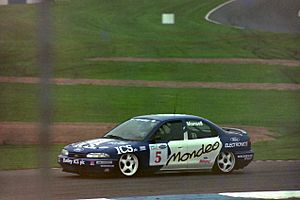 Nigel Mansell - Ford Mondeo Si exits the Old Hairpin at the 1993 TOCA Shootout, Donington (50094067821)