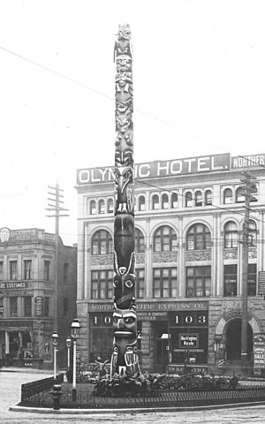 Pioneer Square totem pole with the Olympic Block in the background, Seattle, ca 1911 (WARNER 629) (cropped).jpeg