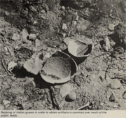 Plundered Native American grave site with broken pottery