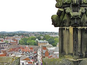 Wrexham town centre overlooked by 16th century grotesques on one of the sixteen pinnacles of St Giles' Church