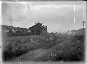 A steam train and locomotive on parallel railway lines, Maungaturoto. ATLIB 292915
