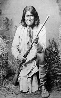 Geronimo (Goyathlay), a Chiricahua Apache, full-length, kneeling with rifle, 1887 - NARA - 530880