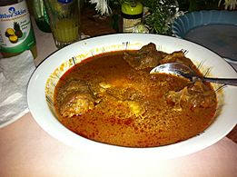 Ghanaian Fufuo in light (tomato) soup with goat