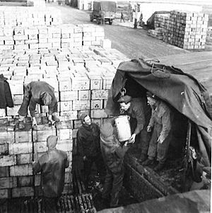 Lorries being loaded with supplies of food at an Army Supply Depot
