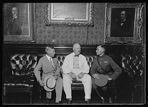 Lt. Russell L. Manghan, famous transcontinental dawn-to-dusk flyer reported to the War Dept. today about his flight. This photo shows Lt. Manghan telling Secy. of War Week and Gen. Mason LCCN2016887382
