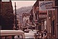 MAIN STREET OF LOGAN, WEST VIRGINIA, SHOWING A NARROW STREET WITH PARKING ON ONLY ONE SIDE WHICH IS TYPICAL IN MANY... - NARA - 556422