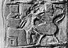 Fragment of a kudurru depicting a girtablullu (right)