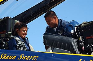 US Navy 060821-N-4729H-108 Aviation Machinist's Mate 1st Class Patrick Palma, a crew chief for the Blue Angels aerial demonstration team, helps local CBS TV reporter Anne-Marie Green prepare for her orientation flight.jpg