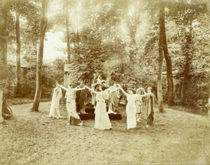 A gathering of women including Eva Palmer, Natalie Barney, and Liane de Pougy in Barney's garden in Neuilly